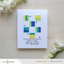 Greeting card with geometric design and floral elements on a wooden surface