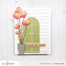 Card with green door, pink flowers, and 'Wishing you smiles' sentiment on a white background.