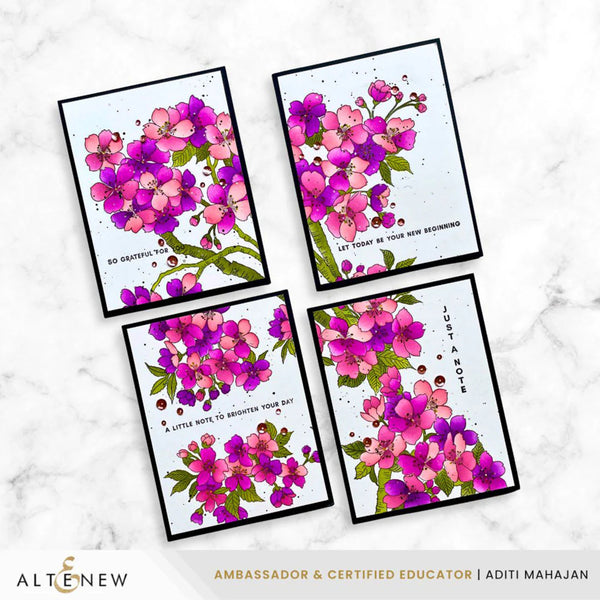 Four floral cards with pink and purple flowers on a marble background, featuring the brand 'Altenew'.