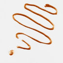 Drizzle of brown sauce on a white background