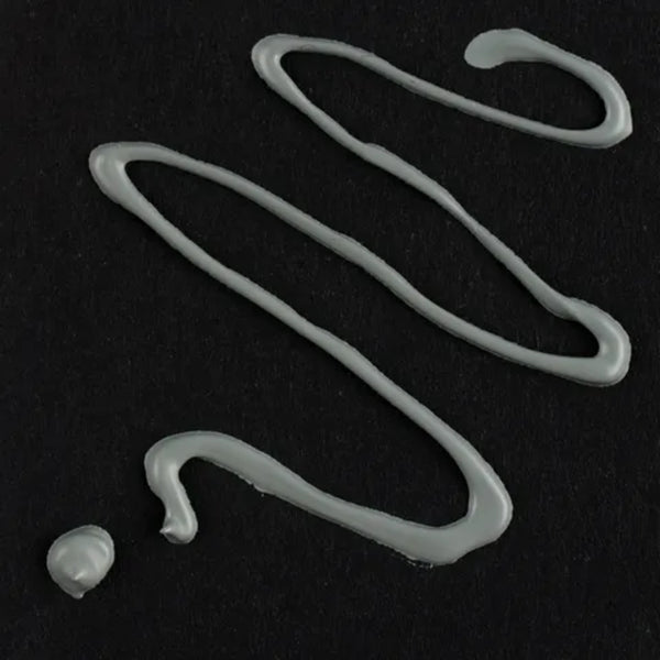 White silicone hooks on a black background