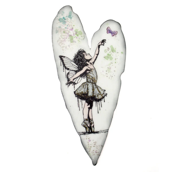 Heart-shaped pillow with fairy design on a white background