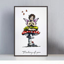 Framed artwork of a fairy sitting on a mushroom with butterflies, titled 'Thinking of you'.