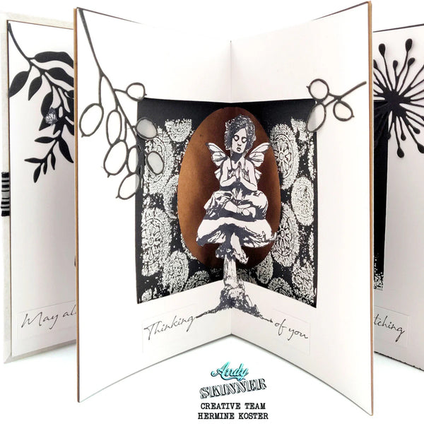 Open card with black and white floral design and a fairy illustration, featuring the Andy Skinner Creative Team logo.