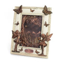 Decorative wall art with fairies, butterflies, and a mountain scene on a white background