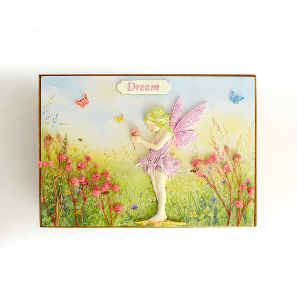 Fairy in a garden with flowers and butterflies, featuring the word 'Dream'.