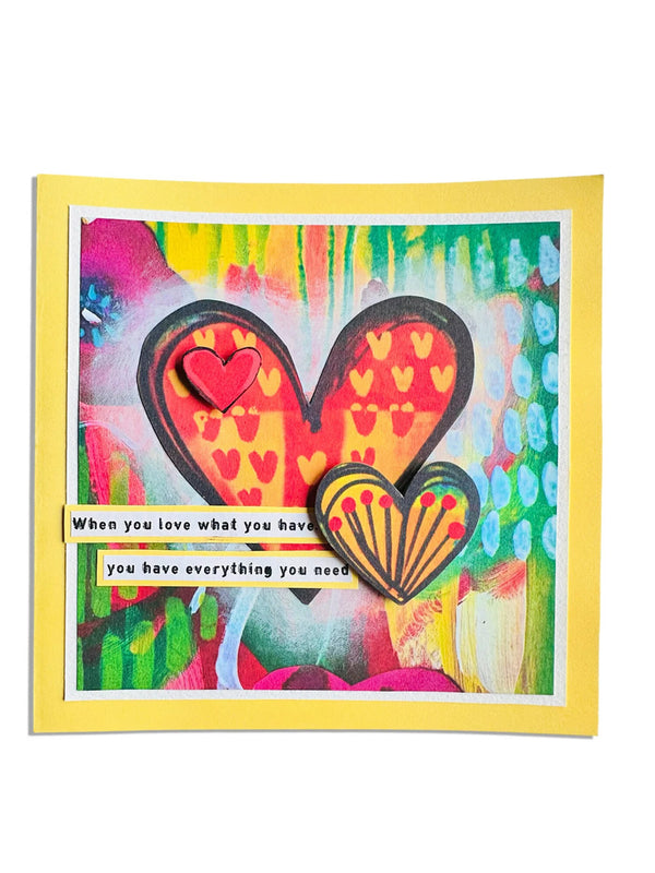 Colorful card with heart design and motivational quote on a white background