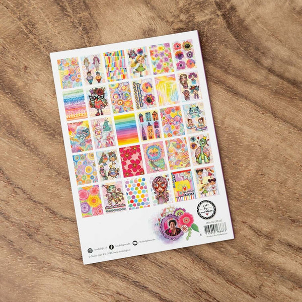 Sheet of colorful stickers on a wooden surface