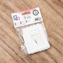 Packaged white plastic parts with a label on a wooden surface