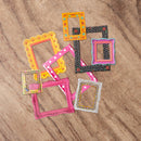 Colorful picture frames on a wooden surface