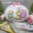 Decorative round embellishment with cartoon animals and flowers, surrounded by crafting supplies on a textured surface.