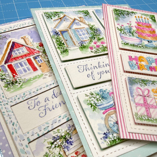 Collection of colorful greeting cards with various designs on a blue grid background.