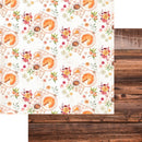 Patterned paper with pie illustrations and flowers on a white background, next to a wooden surface.