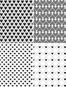 Set of four black and white geometric patterned tiles.