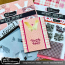 Card making supplies including card panels, stencils, and stamp set on a wooden surface.