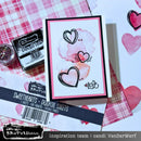 Card with heart designs and ink pad on a patterned background
