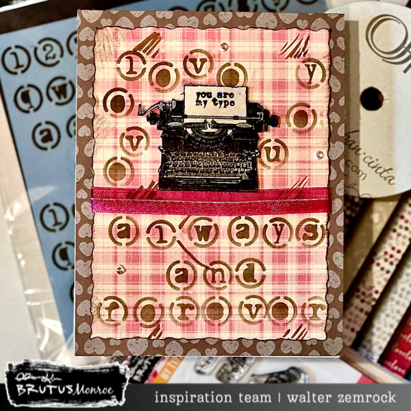 Card with typewriter design and text on a plaid background, surrounded by stationery items.