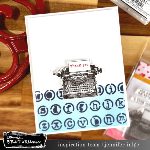 Greeting card with typewriter design and 'thank you' message on a wooden surface.
