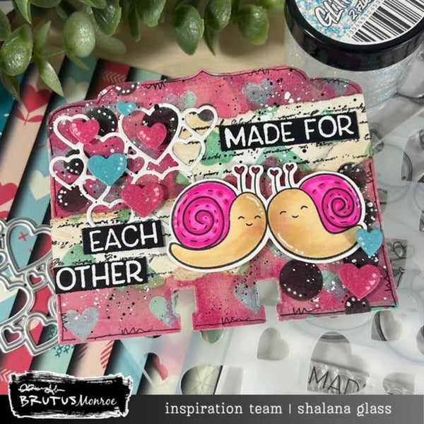 Colorful card with two smiling snails and text 'Made for Each Other' on a craft surface.