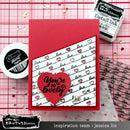 Card with 'You're so lovely' text and red heart on a pink grid background with ink and stamp products.