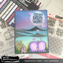 Card with octopus design and 'I love you to the moon and back' text, surrounded by craft supplies.