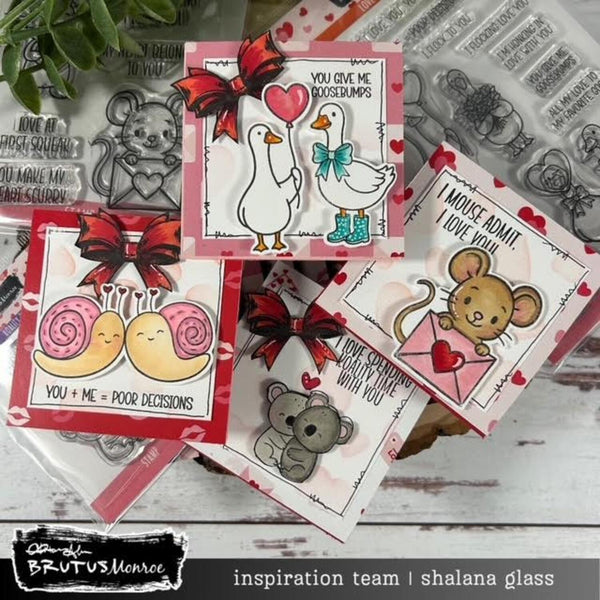 Collection of cute animal-themed cards with stamps and rubber stamps on a wooden surface.