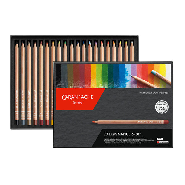 Set of Caran d'Ache colored pencils with packaging displaying a rainbow color swatch.