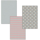 Four pieces of patterned paper with geometric and floral designs on a white background.