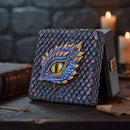 Decorative book with dragon eye design on a stone surface