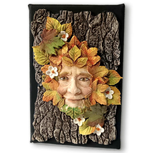 Decorative wall art with a face made of leaves and flowers on a textured background