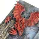 Red dragon sculpture on a textured stone surface