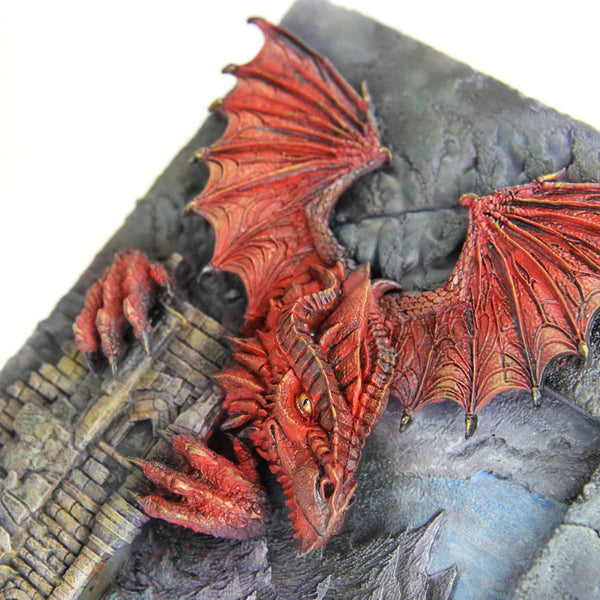Red dragon sculpture on a textured stone surface