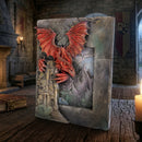 Decorative book with a dragon embossed on the cover in a medieval setting