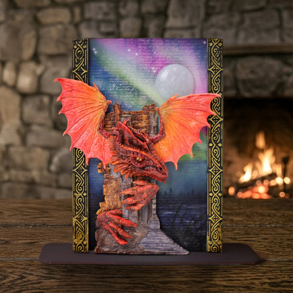 Decorative bookend with a dragon design against a stone wall and fireplace background