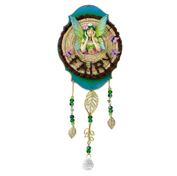 Decorative wall hanging with fairy design and rattan basket on a white background