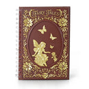 Notebook with gold fairy and floral design on a white background
