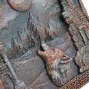 Decorative plaque with a wolf howling at the moon and castle design.