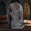 Decorative stone arch with dragon sculptures on a dark background