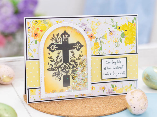 Greeting card with floral design and cross on a decorative stand.