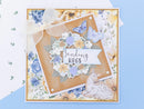 Greeting card with floral design, butterfly, and 'Sending Hugs' text on a blue background