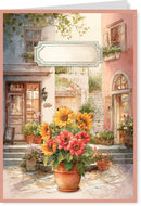 Greeting card with a colorful flower arrangement in front of a picturesque Italian street scene.