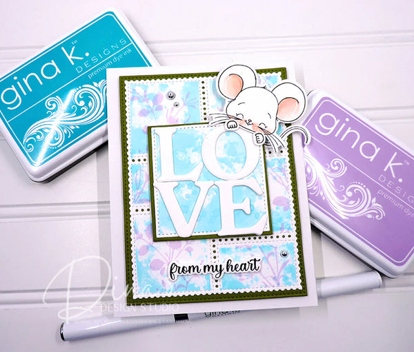 Card with 'LOVE from my heart' text and mouse design, surrounded by Gina K. Designs stamp pads.
