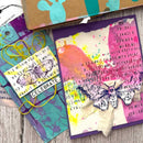 Colorful art cards with butterfly designs on a wooden surface