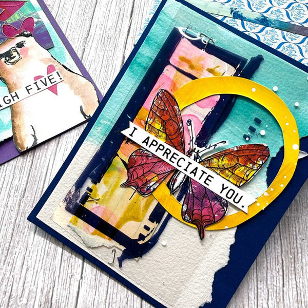 Colorful card with butterfly design and 'I appreciate you' text on a wooden surface.