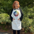 Person wearing a white apron with a colorful design outdoors