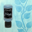 Bottle of Dylusions Robin's Egg Paint on a blue background with leaf pattern