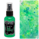 Green ink spray bottle with a colorful watercolor background