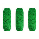 Three skeins of green yarn on a white background