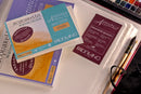 Packaging of Fabriano Artistic watercolor paper with a brush on a white surface.