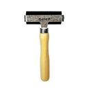 Rubber stamp with wooden handle and metal blade on a white background